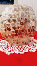 Handcrafted mother of pearl mosaic oval vase with intricate iridescent patterns, showcasing elegant craftsmanship and decorative design.