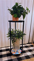 Handcrafted 2-tier rainbow mosaic plant stand with colorful tiled surfaces and sturdy wooden legs for indoor or outdoor plants.
