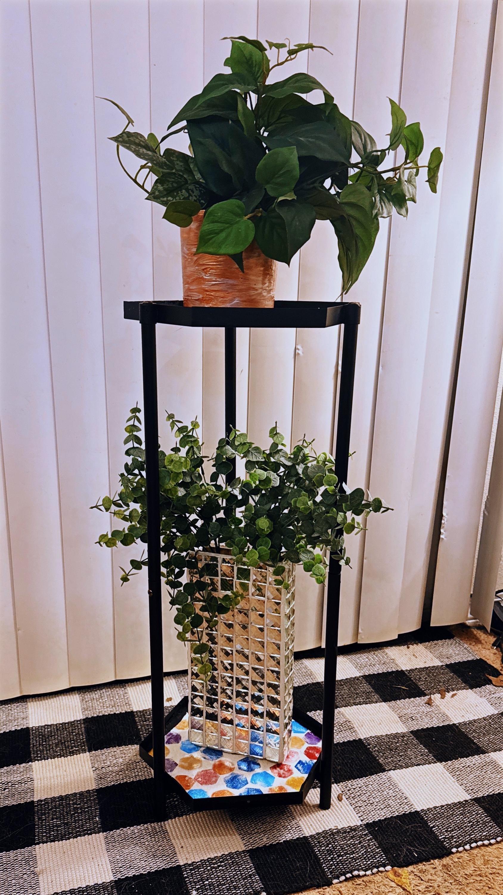 Handcrafted 2-tier rainbow mosaic plant stand with colorful tiled surfaces and sturdy wooden legs for indoor or outdoor plants.
