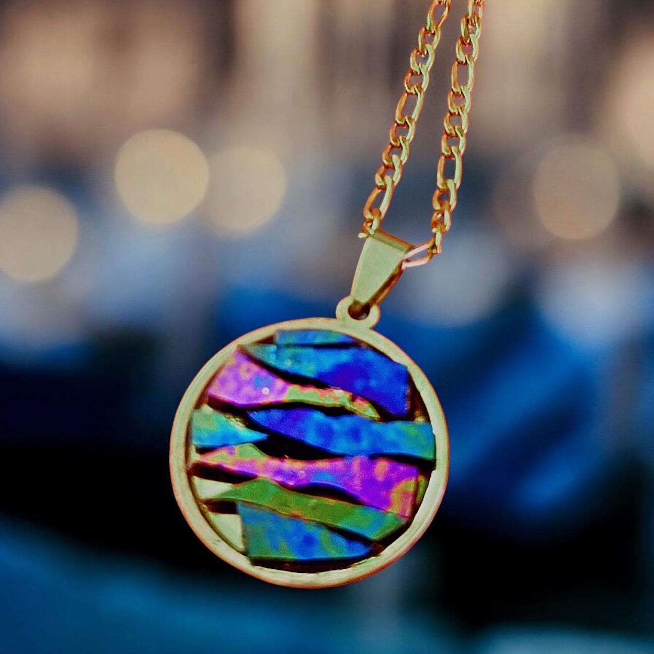 Colorful pendant necklace with multicolored beads and silver chain, stylish jewelry accessory.