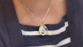 Vintage initial charm necklace with a silver chain and personalized initial pendant, styled for a classic, elegant look.