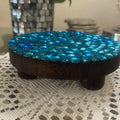 Artisanal turquoise cabochon mosaic plant stand by Miss Bette's Creations featuring colorful tile patterns and sturdy wood construction.