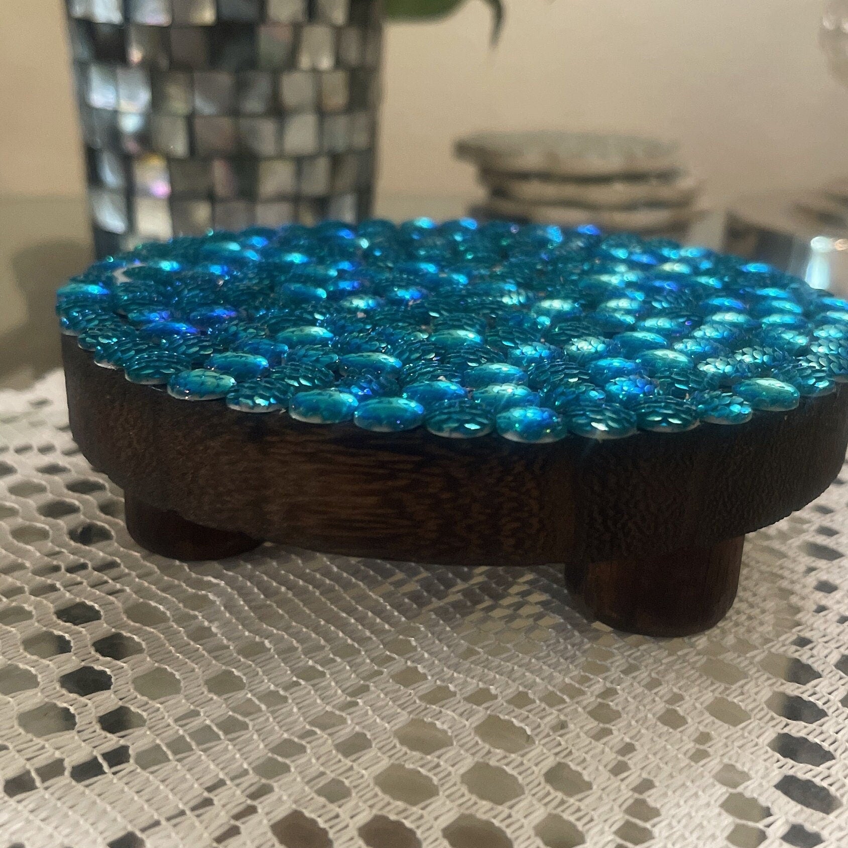Artisanal turquoise cabochon mosaic plant stand by Miss Bette's Creations featuring colorful tile patterns and sturdy wood construction.