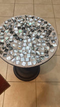 Handmade mosaic round side table with colorful tiled surface and wooden legs, showcasing unique craftsmanship and vibrant design.