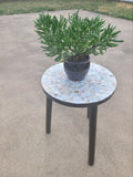 Tall Capiz shell mosaic plant stand with round top and decorative shell patterns, perfect for displaying potted plants.