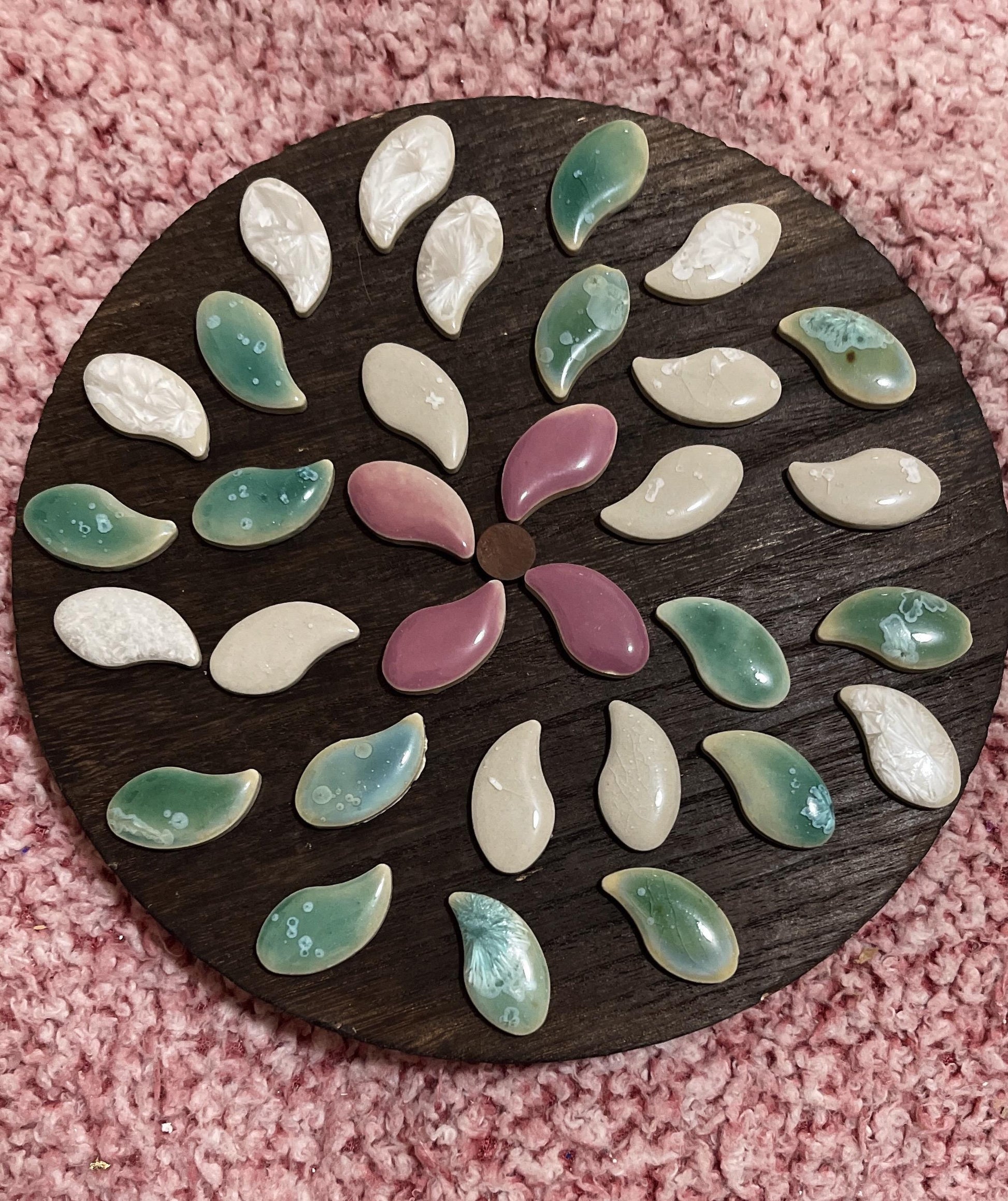 Handcrafted petal mosaic wooden plant stand with colorful floral design, ideal for displaying potted plants indoors or outdoors.