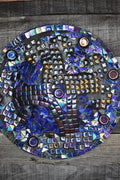 Handcrafted iridescent mosaic wall art with colorful glass tiles, showcasing intricate design and vibrant, reflective surface.