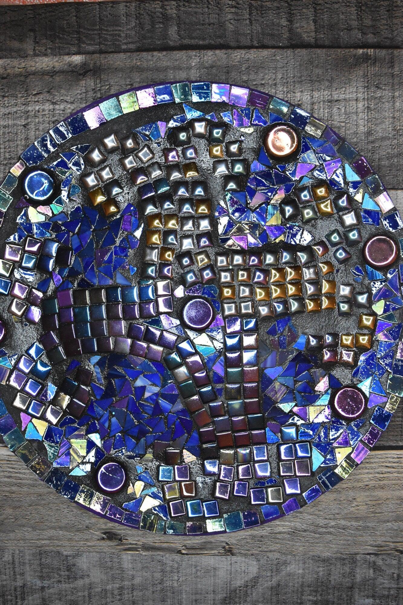 Handcrafted iridescent mosaic wall art with colorful glass tiles, showcasing intricate design and vibrant, reflective surface.