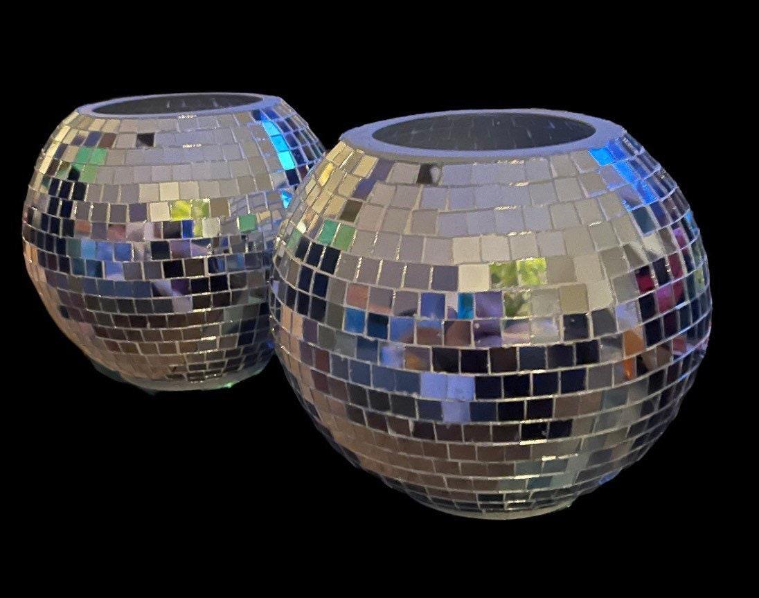 Reflective disco ball planter and mosaic decorative bowl with colorful, shiny surface on a white background.