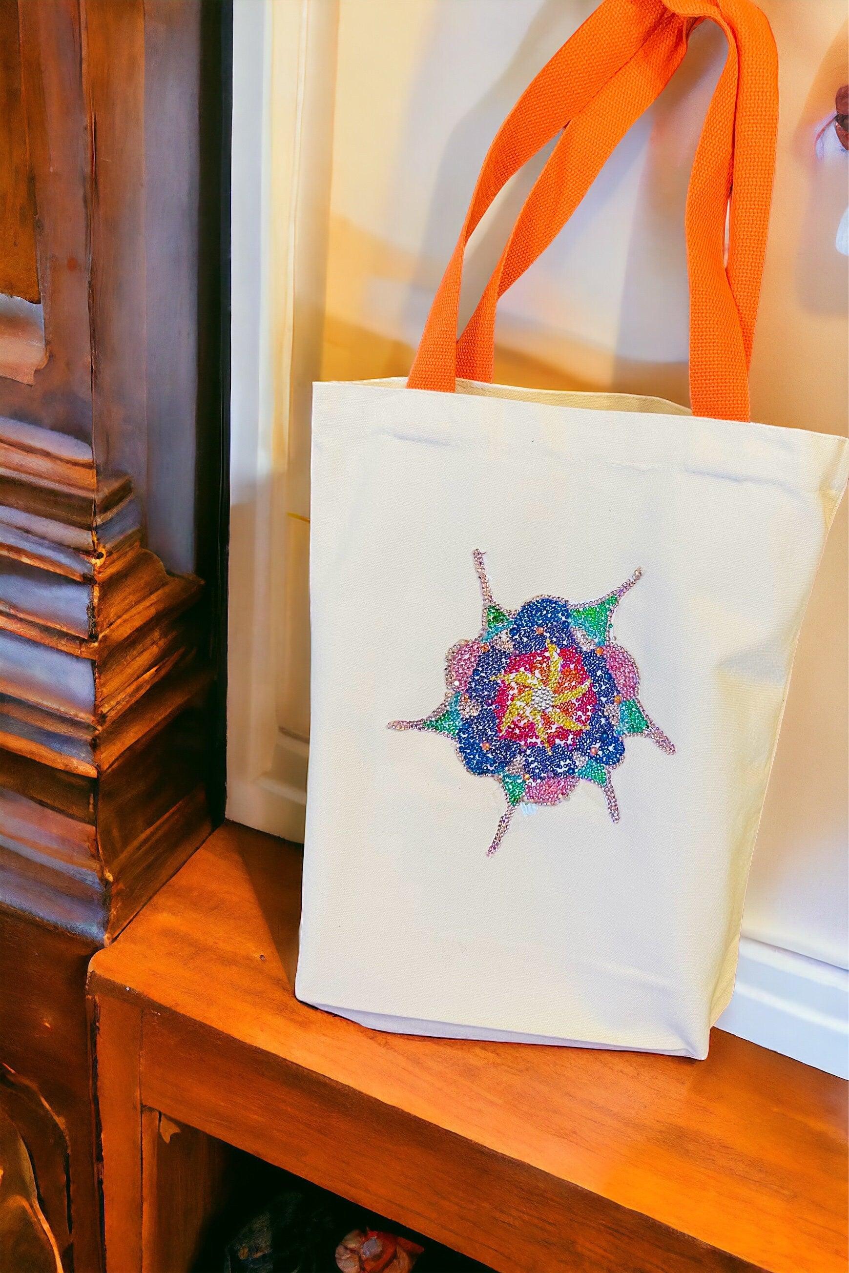 Handmade sparkling starburst diamond art canvas tote bag with vibrant design and sturdy handles, perfect for stylish carrying.