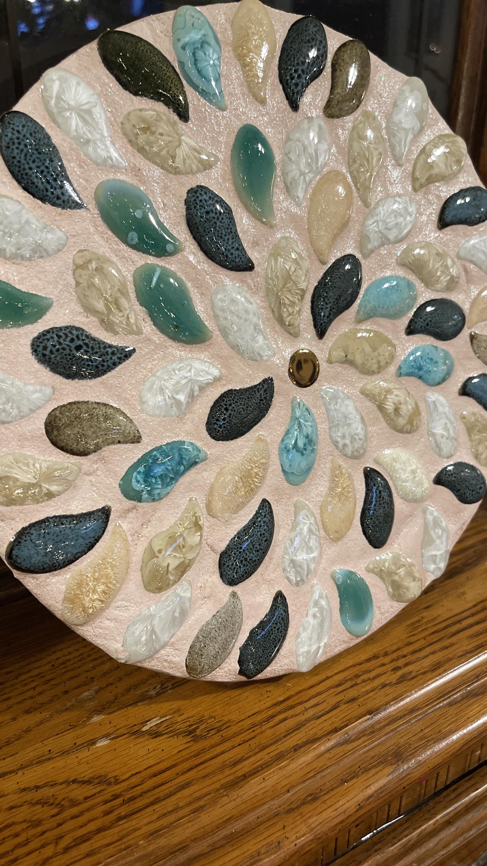 Handcrafted botanical petal mosaic plant stand with colorful floral design, ideal for displaying potted plants indoors or outdoors.