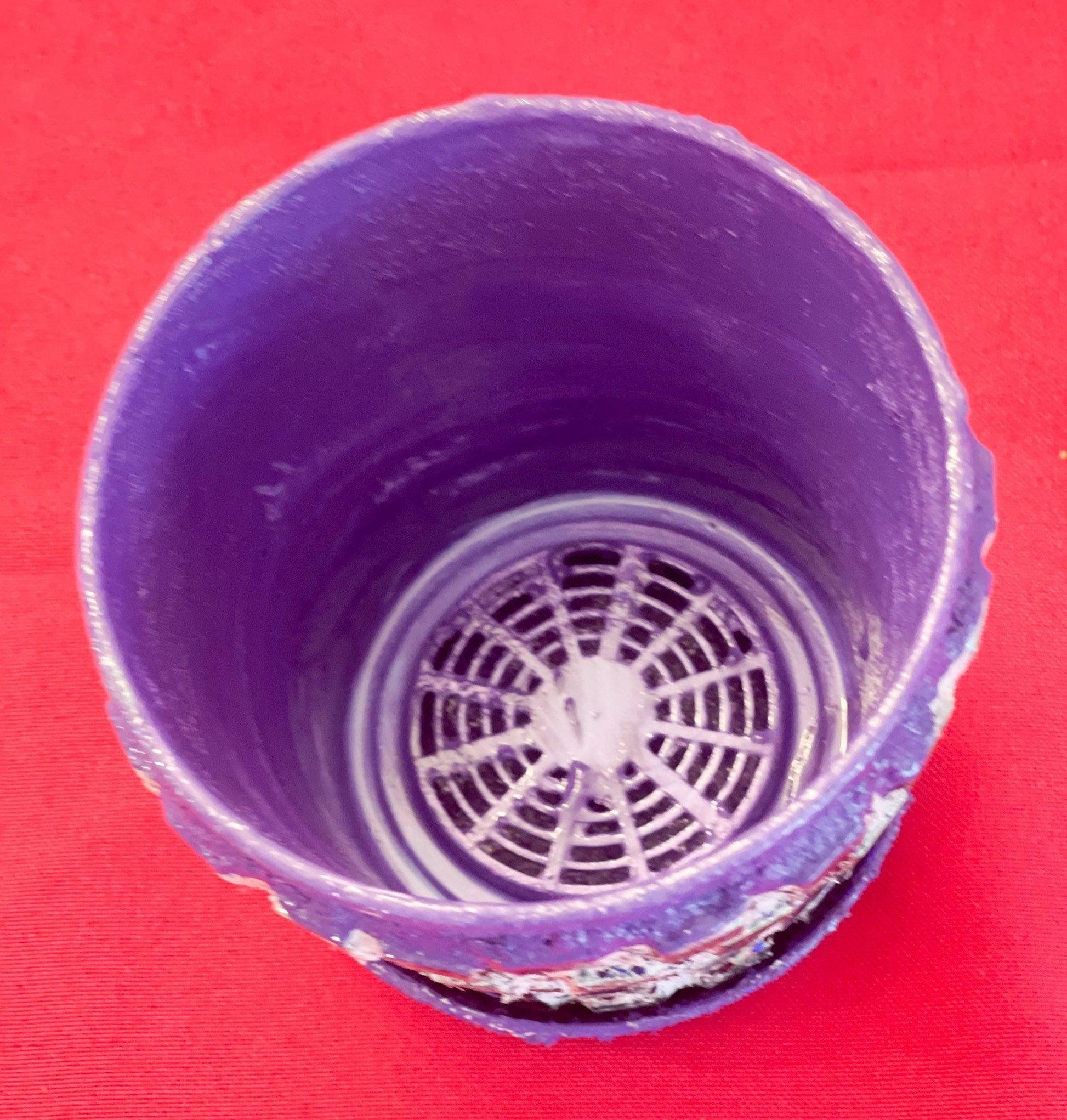 Purple and green mosaic flower pot with floral design, showcasing vibrant ceramic pattern and craftsmanship.