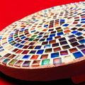 Handcrafted 10-inch rainbow mosaic plant stand by Miss Bette's Creations with colorful tiled design for indoor or outdoor use.
