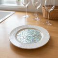 Multicolored rainbow mosaic fruit plate with a variety of fresh fruits arranged in vibrant patterns.