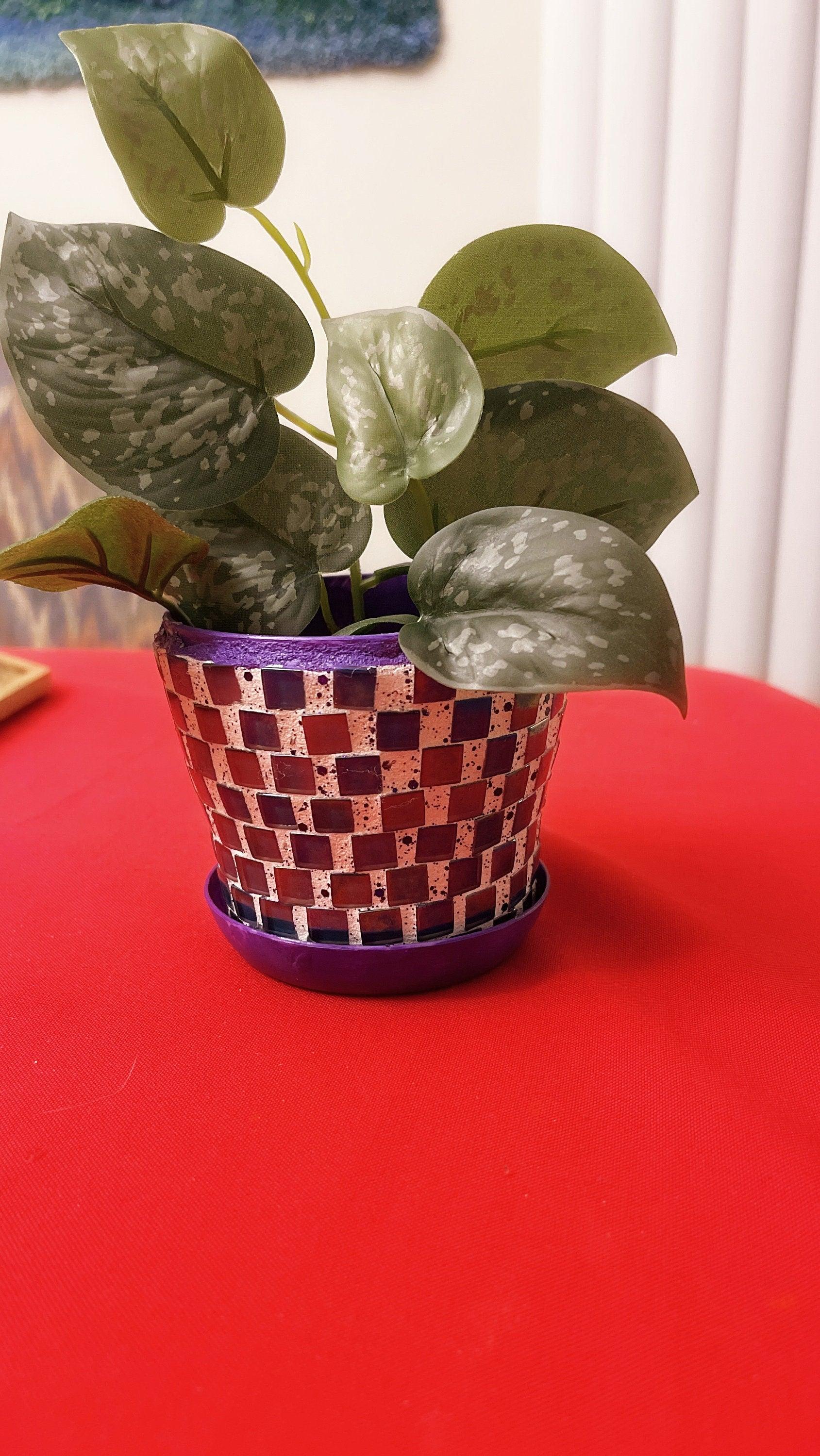 Colorful purple and green mosaic flower pot with floral design, perfect for indoor or outdoor plants.