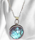 Sparkling aqua blue pendant necklace with silver chain, showcasing a vibrant, faceted gemstone on a delicate jewelry piece.