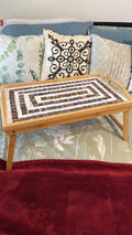 Rustic bamboo bed tray with stone mosaic inlay, featuring sturdy handles and a natural finish for serving breakfast or snacks.