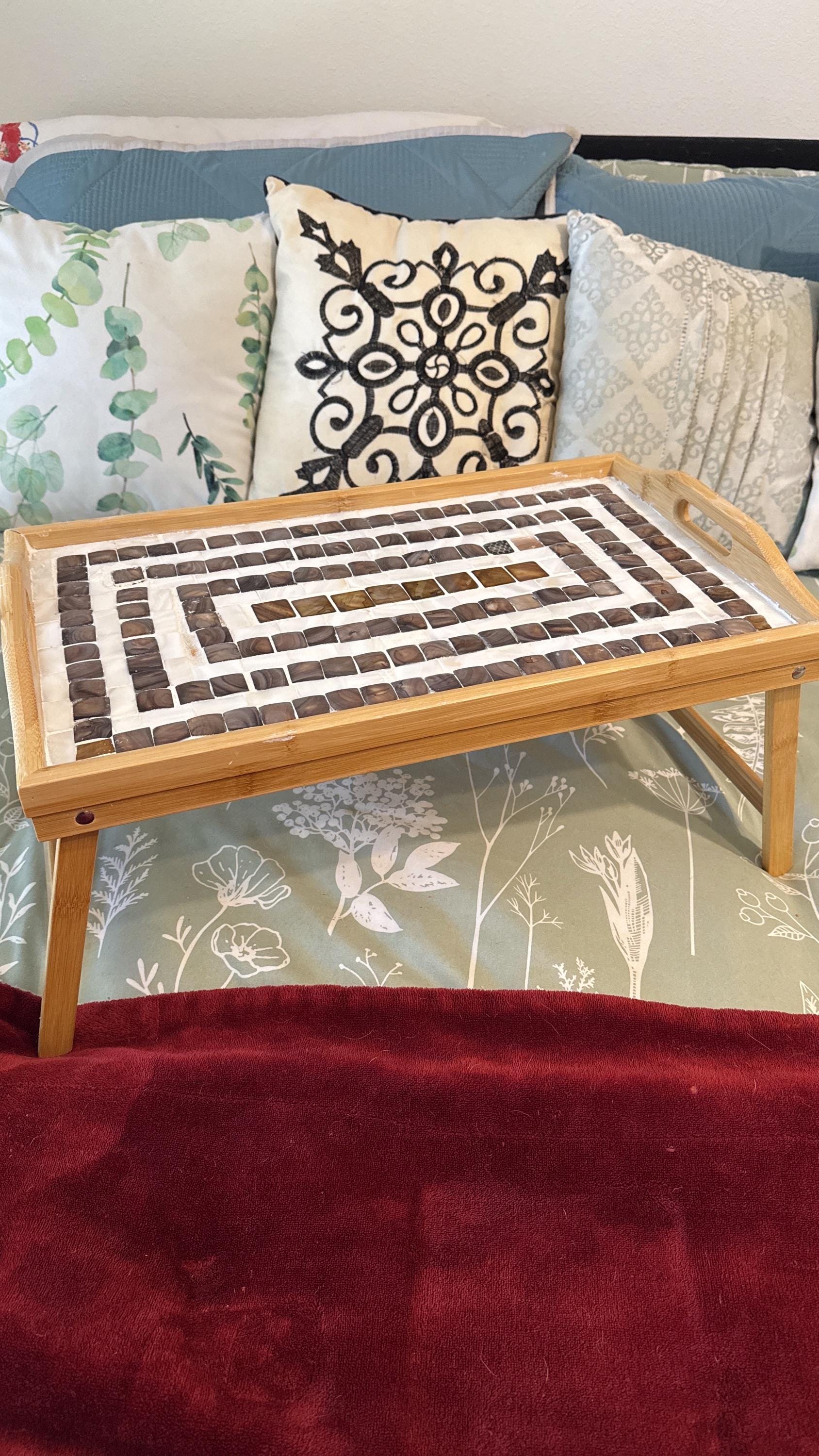 Rustic bamboo bed tray with stone mosaic inlay, featuring sturdy handles and a natural finish for serving breakfast or snacks.