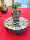 Handcrafted small rainbow mosaic plant stand with colorful tile design, perfect for displaying potted plants indoors or outdoors.
