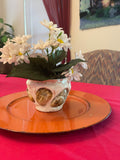 Handcrafted mini planter with seashell and sandstone accents, perfect for small plants or succulents.