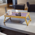 Handcrafted bamboo laptop tray with pink cushion, designed for comfortable workspace and stylish home office use.
