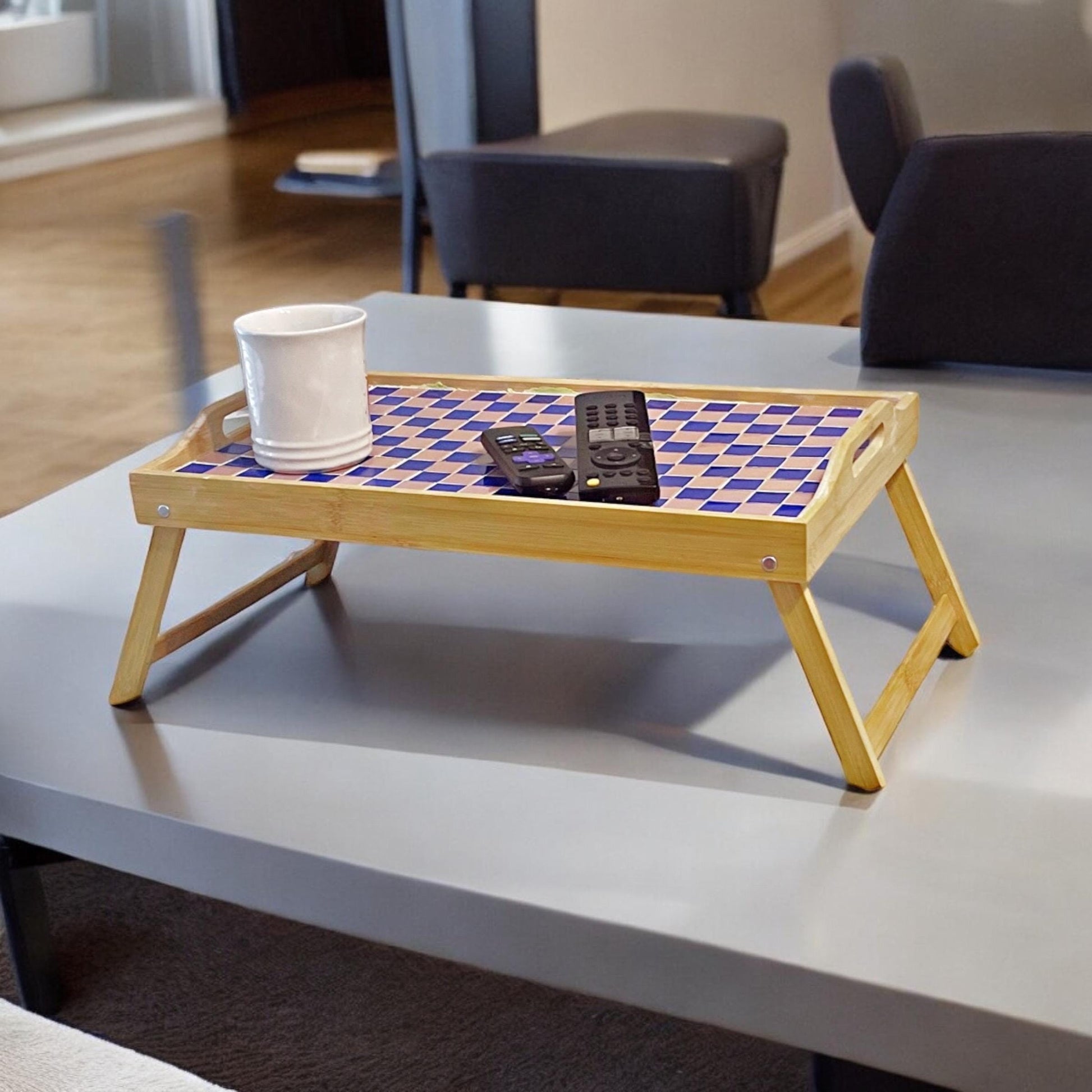 Handcrafted bamboo laptop tray with pink cushion, designed for comfortable workspace and stylish home office use.