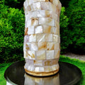 Handcrafted tapered vase with mother of pearl mosaic design, showcasing intricate, shimmering patterns on a ceramic surface.