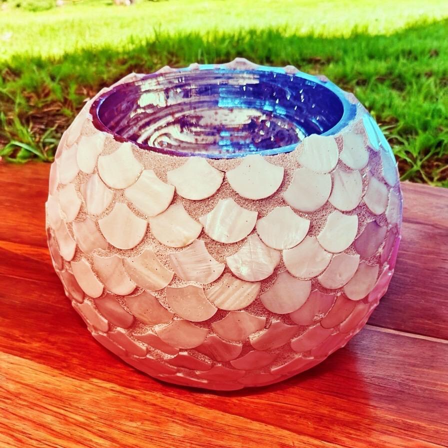 Handcrafted scalloped capiz shell globe vase with a delicate, shimmering design, perfect for elegant home decor.