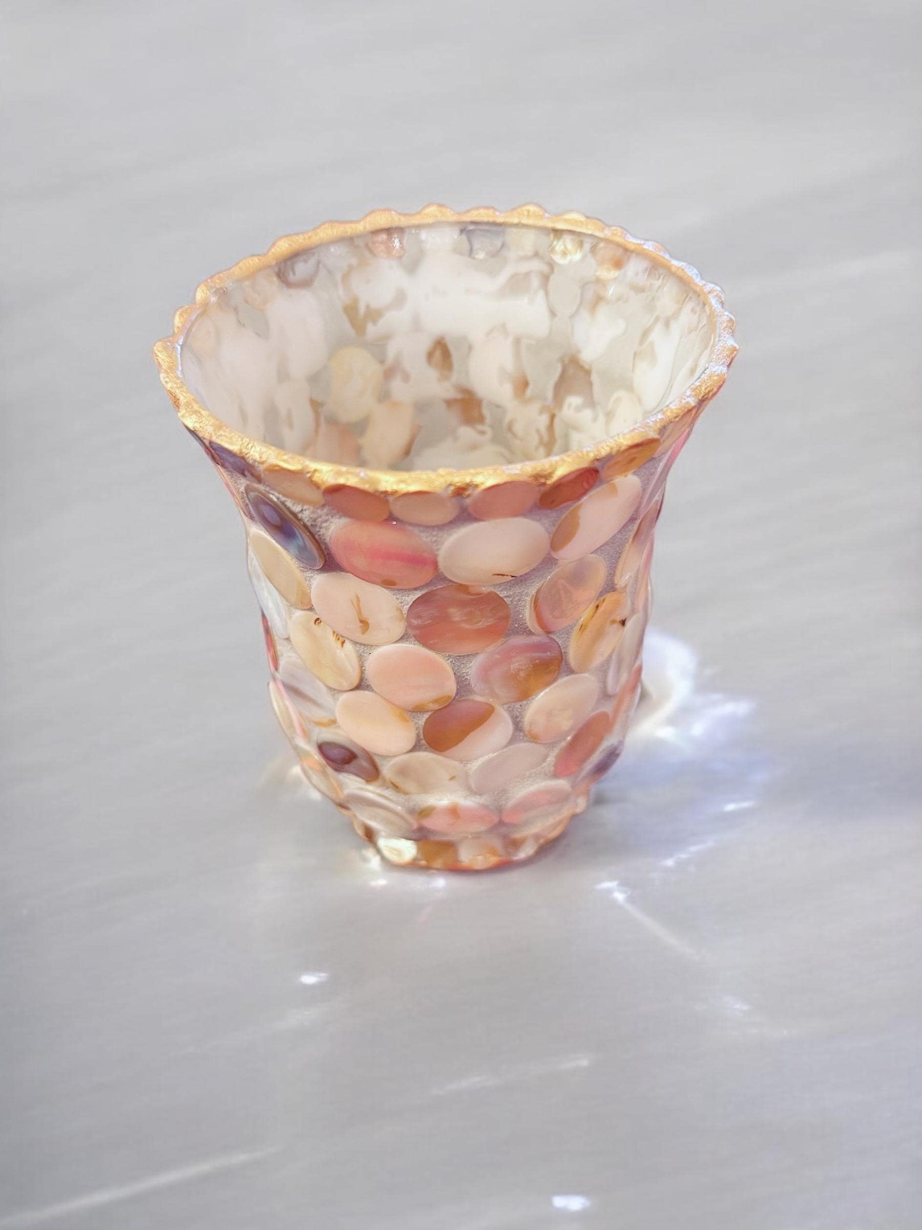 Handcrafted scalloped Capiz shell mosaic vase with a smooth, rounded design showing iridescent shell patterns and a glossy finish.