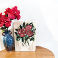 Geometric teal and azure mosaic bed tray with wooden handles, showcasing colorful tile pattern on a white background.