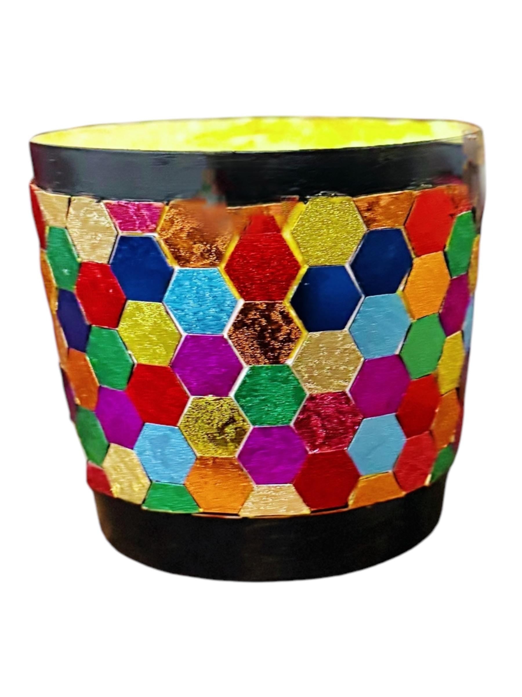 Colorful bouquet of mixed flowers in a rainbow mosaic hexagon planter, showcasing vibrant floral arrangement and decorative planter.