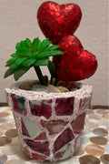 Handcrafted broken china heart mosaic planter with colorful mosaic design, perfect for indoor or outdoor decorative planting.
