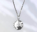 Vintage initial charm necklace featuring a silver chain and personalized letter charm, stylish jewelry accessory.