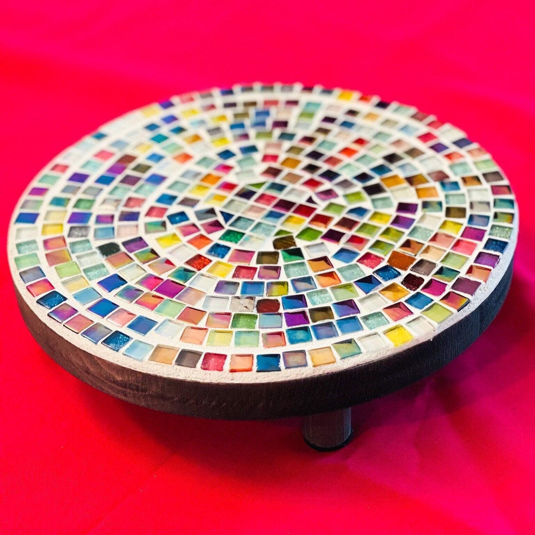 Rainbow glass tile plant stand with colorful glass tiles and metal frame, designed to hold potted plants.