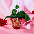 Handcrafted broken china mosaic flower pot with colorful floral design, showcasing intricate mosaic patterns and vibrant craftsmanship.