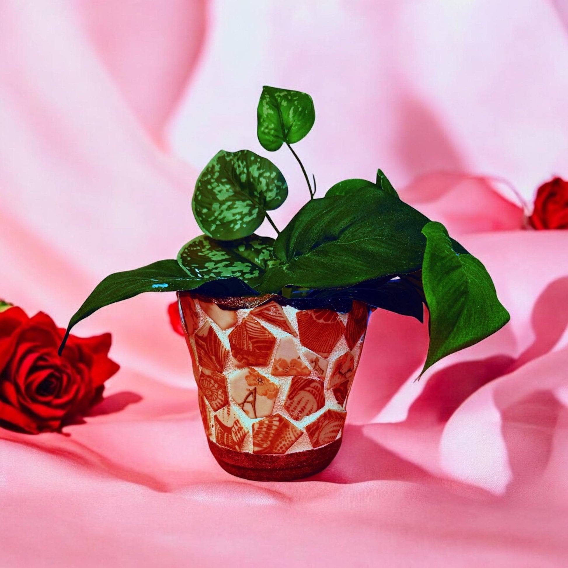 Handcrafted broken china mosaic flower pot with colorful floral design, showcasing intricate mosaic patterns and vibrant craftsmanship.