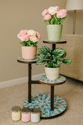 Multi-level 3-tier mosaic plant stand with colorful ceramic trays for indoor or outdoor use, featuring a sturdy metal frame.