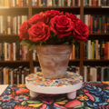 Handcrafted white rainbow mosaic plant stand with colorful tiled design, perfect for displaying indoor or outdoor plants.