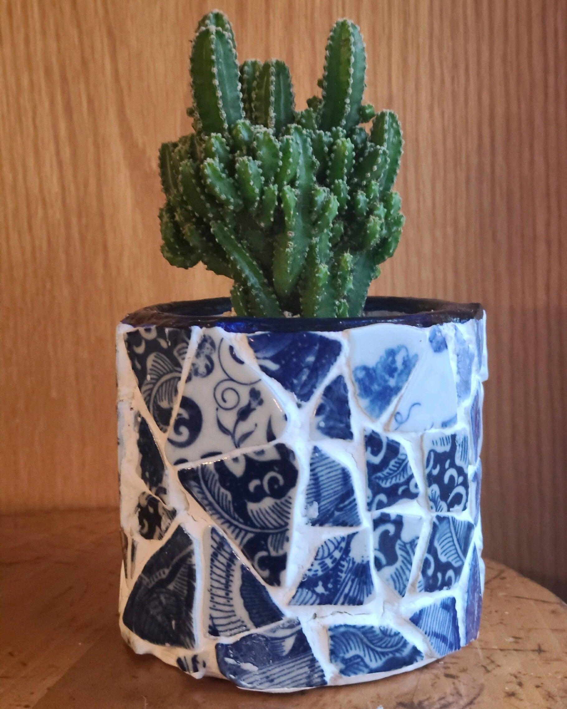 White broken china mosaic planter with intricate design, perfect for indoor or outdoor plant display.