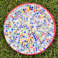 Colorful handcrafted rainbow mosaic decorative plate with intricate patterns, perfect for home decor or display.