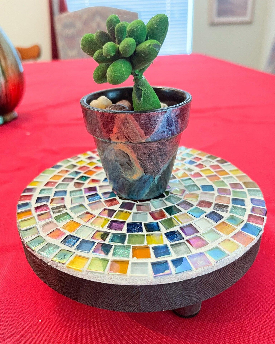 Handmade 7-inch rainbow mosaic plant stand with colorful glass tiles, designed to hold small potted plants.