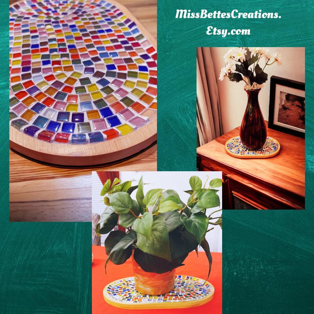 Handcrafted geometric star mosaic wall art with colorful tiles displayed on a wall, showcasing intricate patterns and vibrant design.
