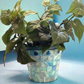 Turquoise mother of pearl flower pot with floral design, decorative ceramic planter for indoor or outdoor use.