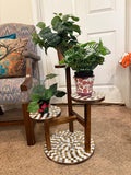 Handcrafted 3-tier mosaic plant stand with colorful tiled shelves for displaying potted plants.