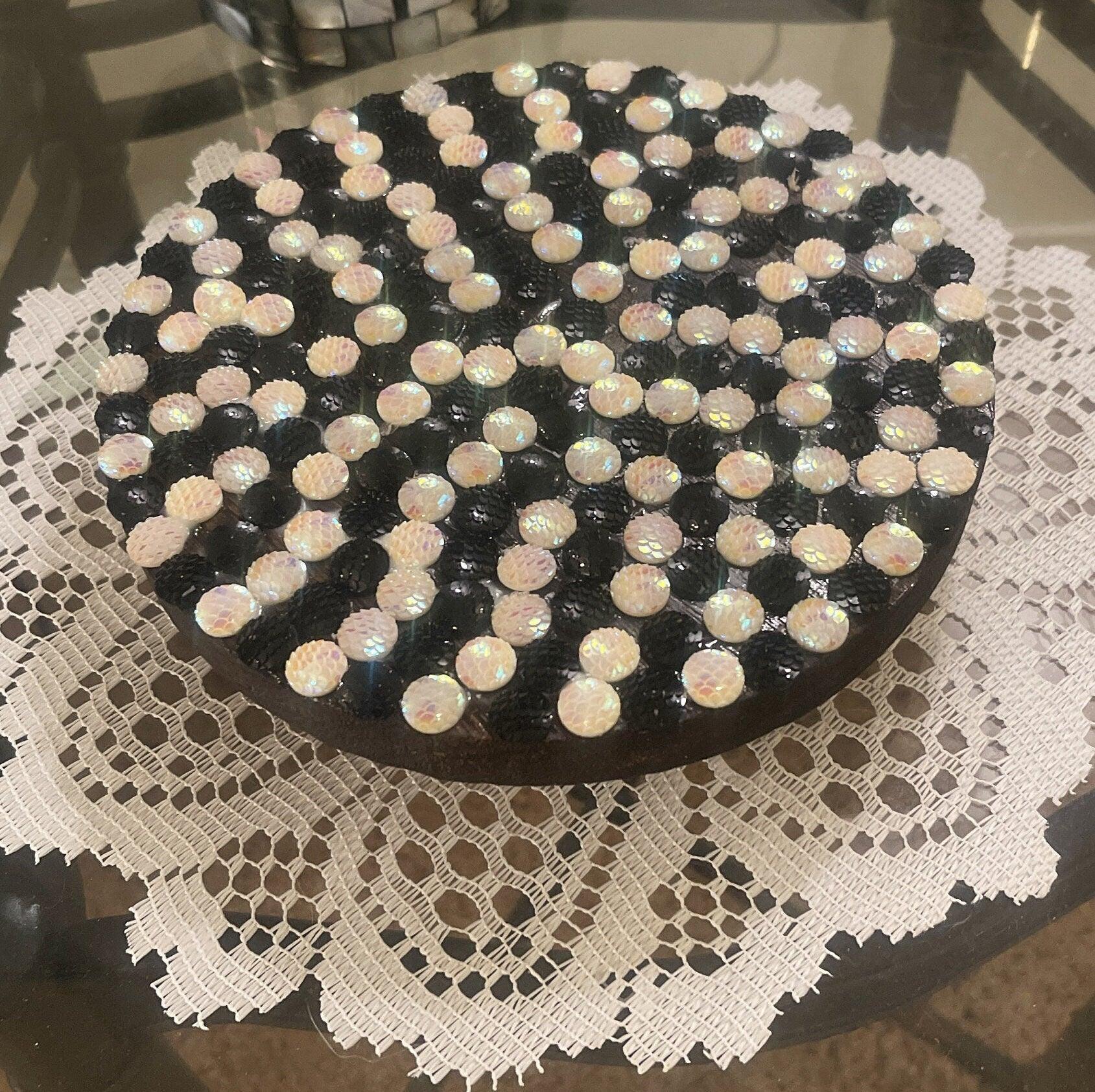 Handmade black and white iridescent mosaic plant stand with intricate tile pattern, designed to hold potted plants beautifully.