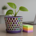 Colorful purple and green mosaic flower pot with floral design, perfect for garden or indoor plant decoration.