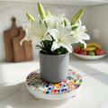 White rainbow mosaic plant stand with handcrafted design, featuring colorful tile patterns and sturdy white frame.