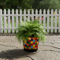 Colorful flower bouquet in a rainbow mosaic hexagon planter, showcasing vibrant blooms and decorative ceramic design.
