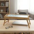 Luxury bamboo bed tray with mosaic inlay, featuring a smooth surface and handles for breakfast or serving in a bedroom setting.