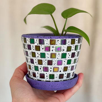 Colorful purple and green mosaic flower pot with a floral design, perfect for adding vibrant decor to indoor or outdoor spaces.